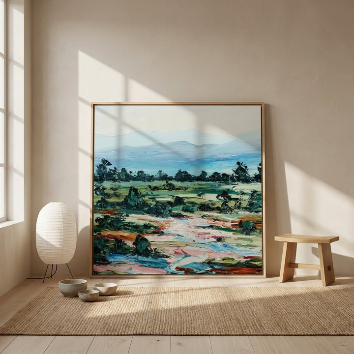 Oversized statement canvas wall art with a natural timber surround leaning against the wall in a warm Japandi dining room