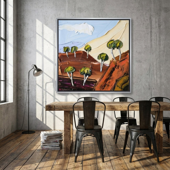 Canvas wall art with a silver leaf surround styled on the wall in an industrial loft dining room