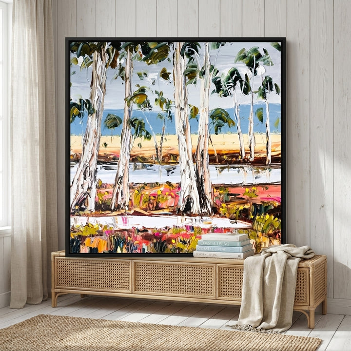 Canvas wall art with a black surround standing on a sideboard in a coastal home office