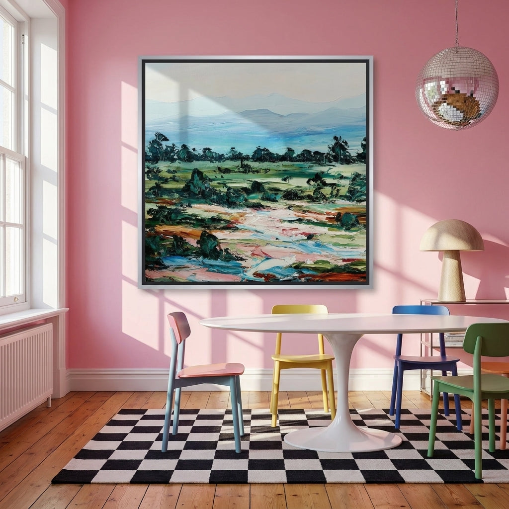 Canvas wall art with a silver leaf surround styled on the wall in a colourful eclectic dining room