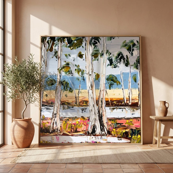 Oversized statement canvas wall art with a natural timber surround leaning against the wall in a Mediterranean dining room