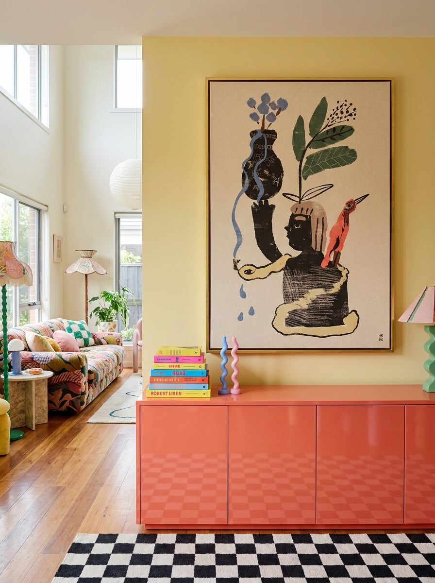 Oversized statement canvas wall art with a gold leaf surround styled on the wall in a colourful eclectic living room