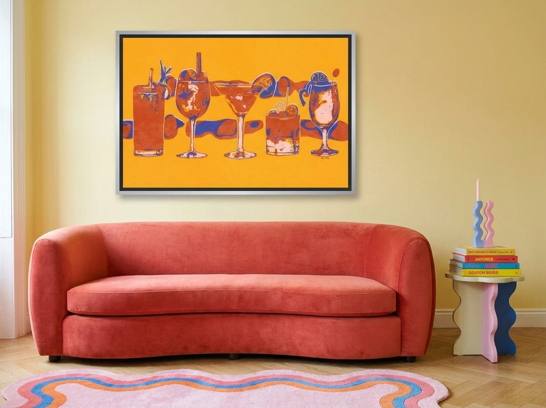 Canvas wall art with a silver leaf surround styled on the wall in a colourful eclectic living room
