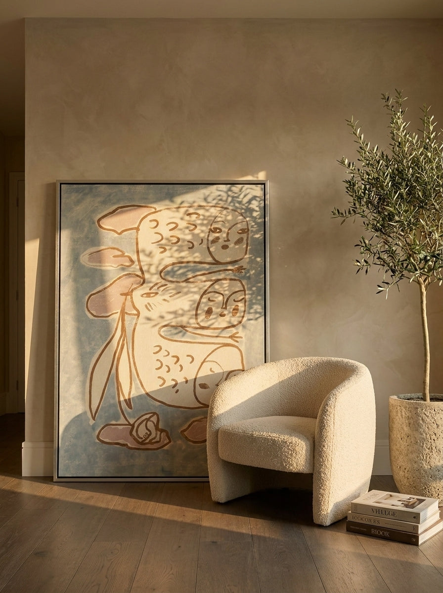 Canvas wall art with a silver leaf surround leaning against the wall in a luxe bedroom