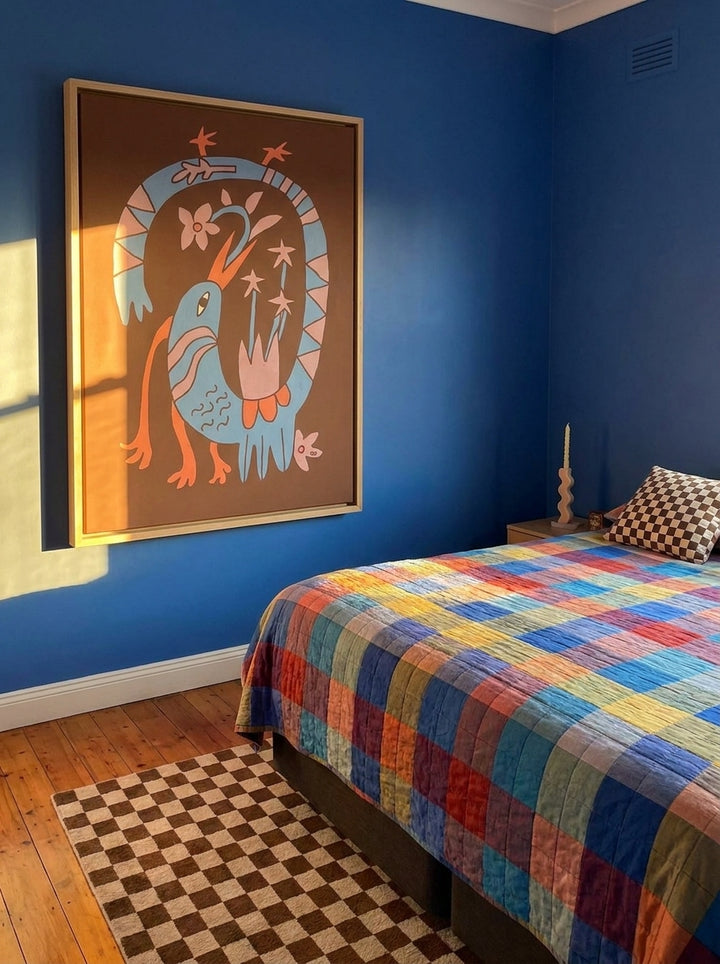 Oversized statement canvas wall art with a natural timber surround styled on the wall in a colourful eclectic bedroom