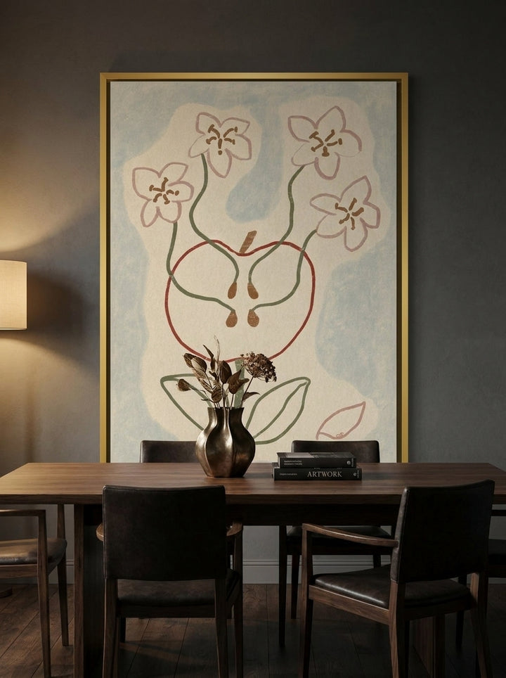 Canvas wall art with a gold leaf surround styled on the wall in a moody dining room