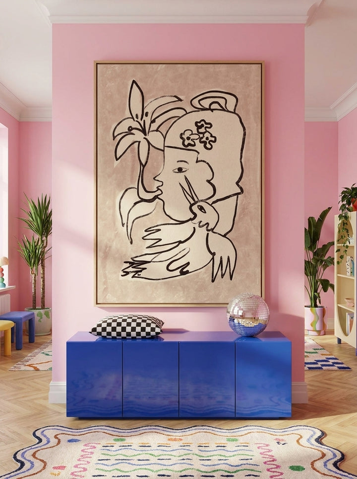 Oversized statement canvas wall art with a natural timber surround styled on the wall in a colourful eclectic living room