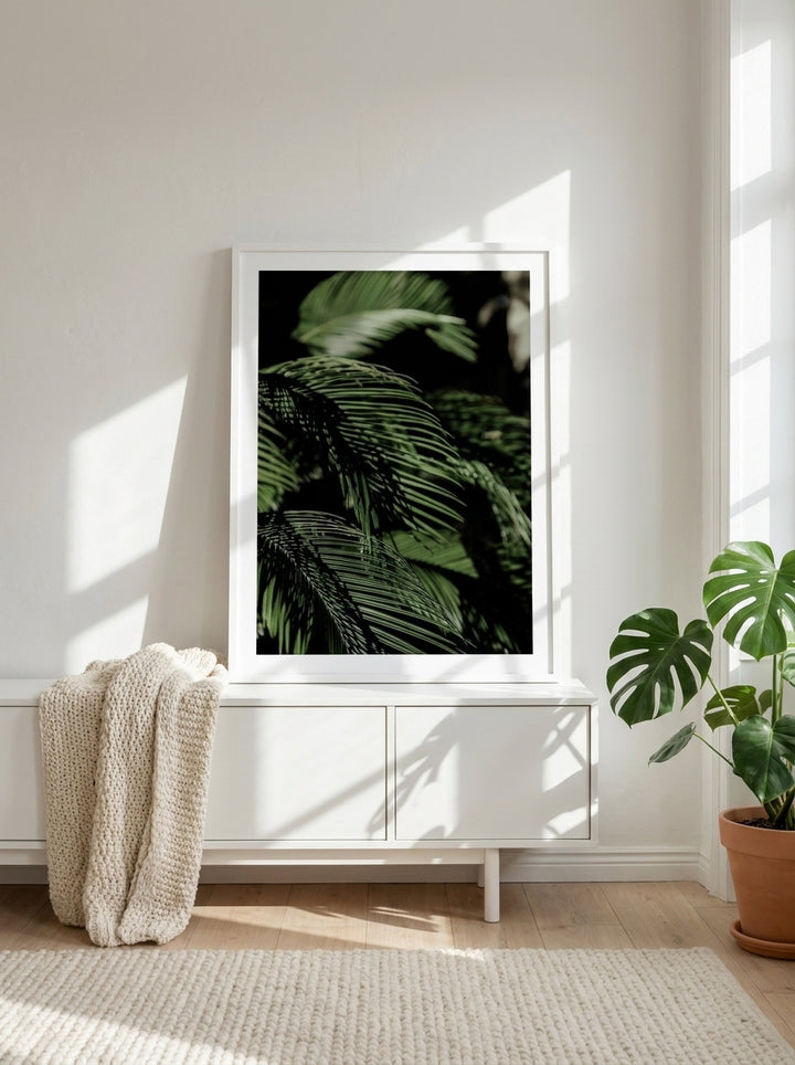 Modern wall art print standing on a sideboard in a bright Scandinavian living room