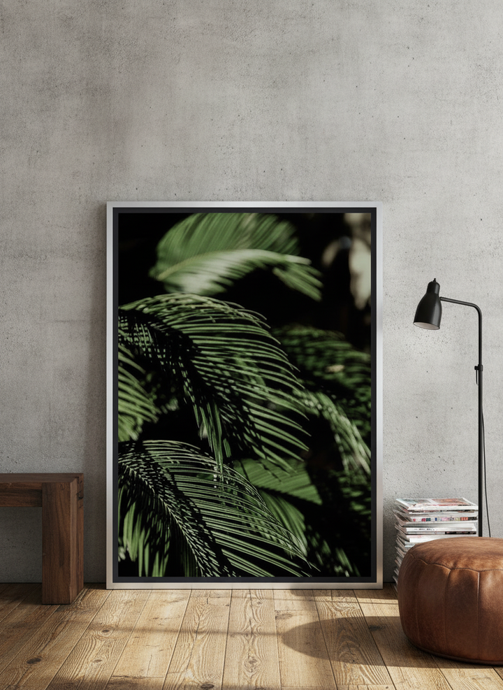 Canvas wall art with a silver leaf surround leaning against the wall in an industrial loft bedroom