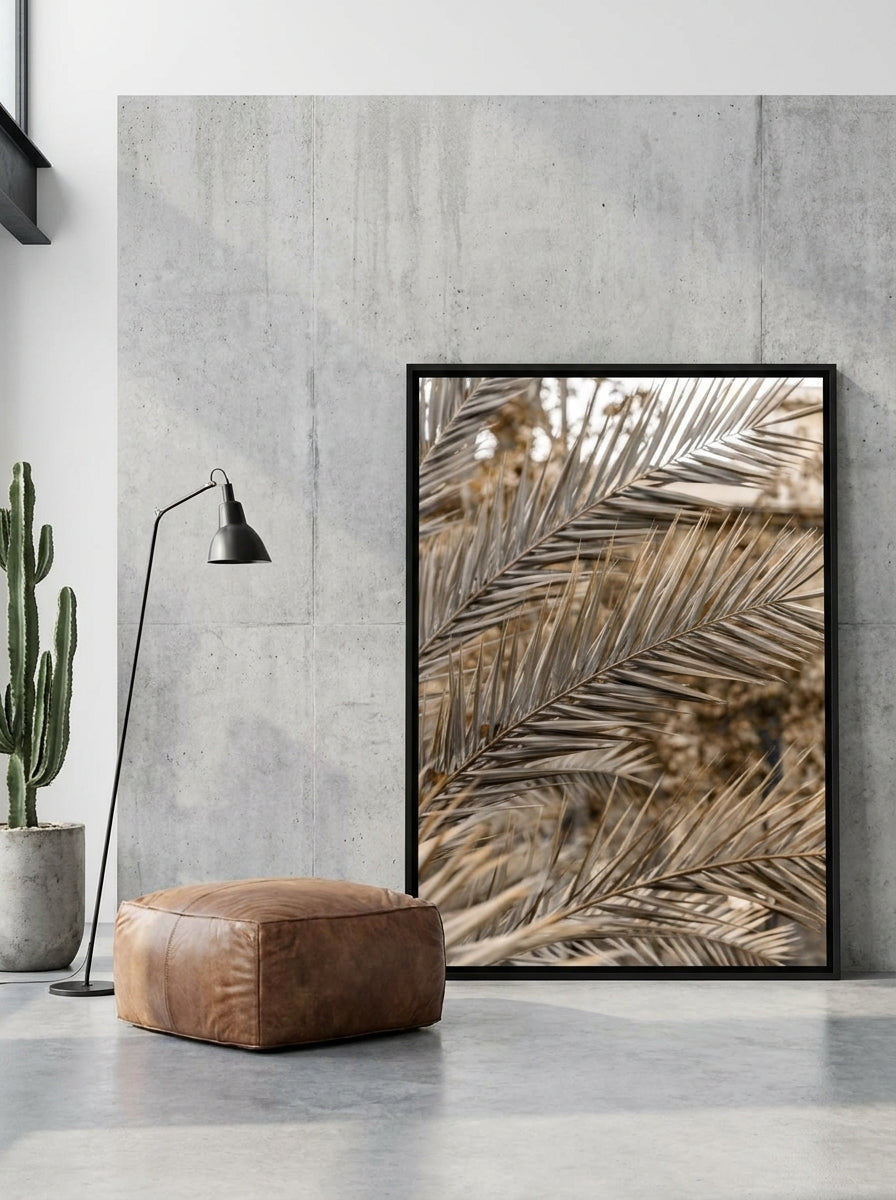Oversized statement canvas wall art with a black surround leaning against the wall in an industrial loft living room