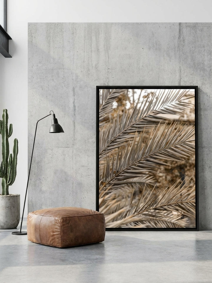 Oversized statement canvas wall art with a black surround leaning against the wall in an industrial loft living room