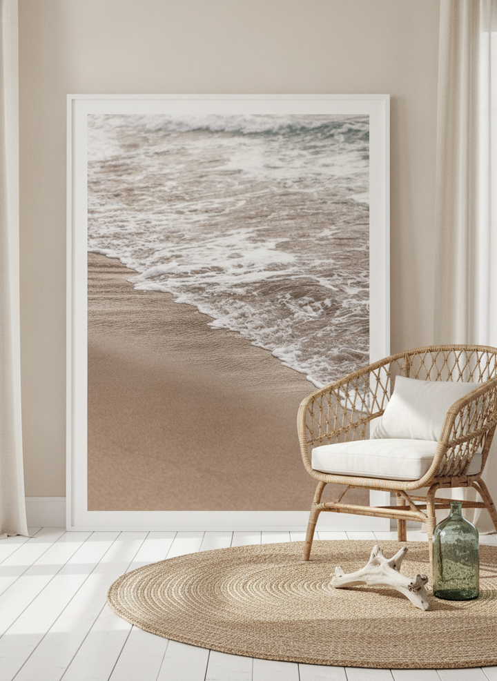 Oversized statement modern wall art print leaning against the wall in a coastal dining room