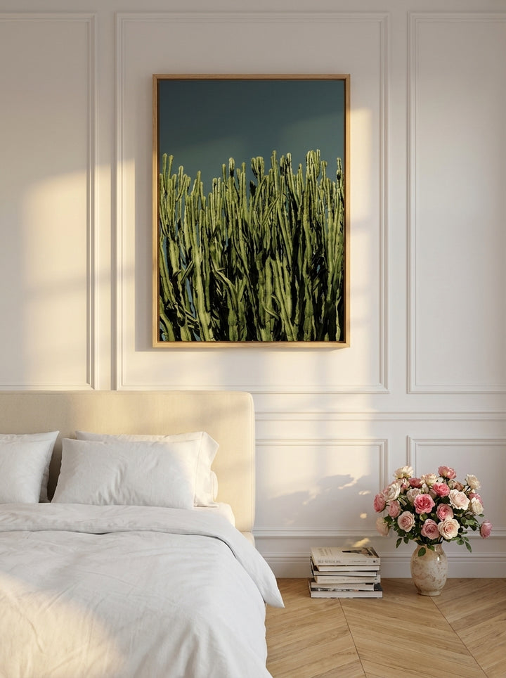 Canvas wall art with a natural timber surround styled on the wall in a Parisian bedroom