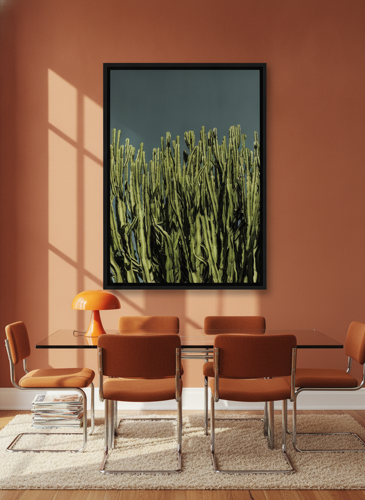 Oversized statement canvas wall art with a black surround styled on the wall in a retro 70s dining room