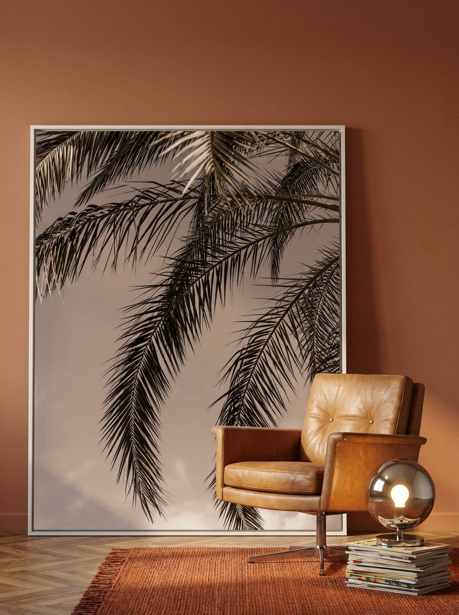 Oversized statement canvas wall art with a white surround leaning against the wall in a retro 70s dining room