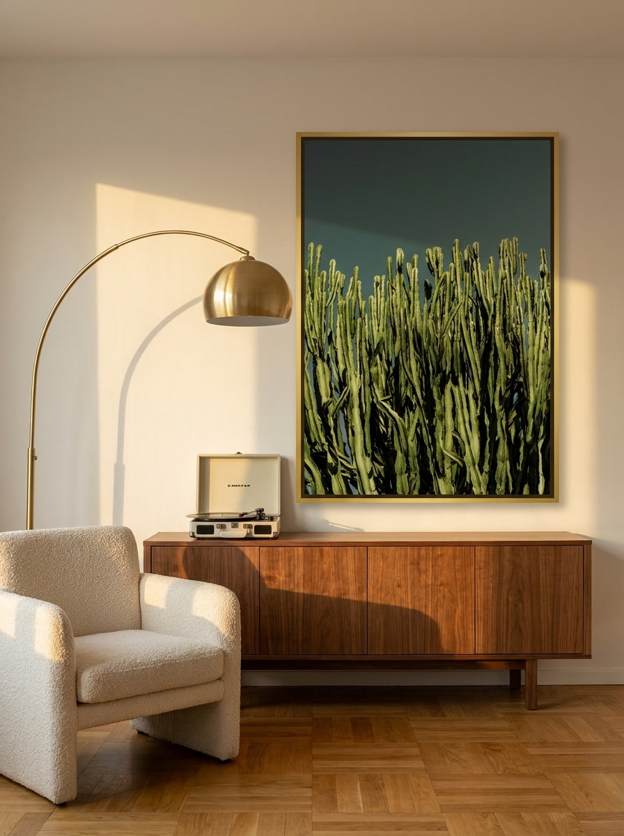 Oversized statement canvas wall art with a gold leaf surround styled on the wall in a mid-century living room