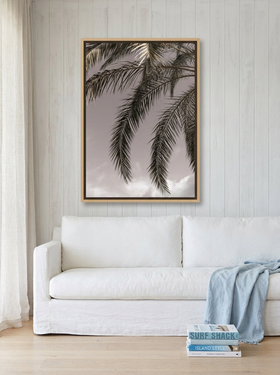 Oversized statement canvas wall art with a natural timber surround styled on the wall in a coastal living room
