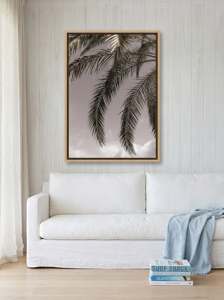 Oversized statement canvas wall art with a natural timber surround styled on the wall in a coastal living room