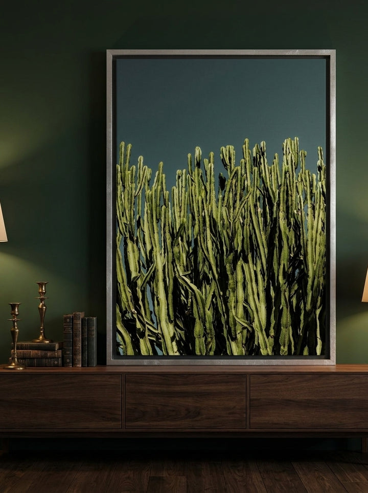 Canvas wall art with a silver leaf surround standing on a sideboard in a moody home office