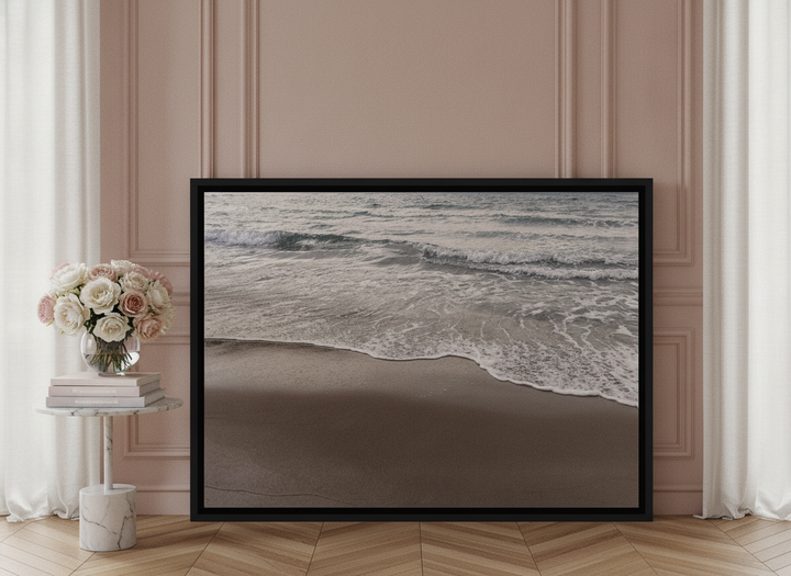 Canvas wall art with a black surround leaning against the wall in a Parisian bathroom