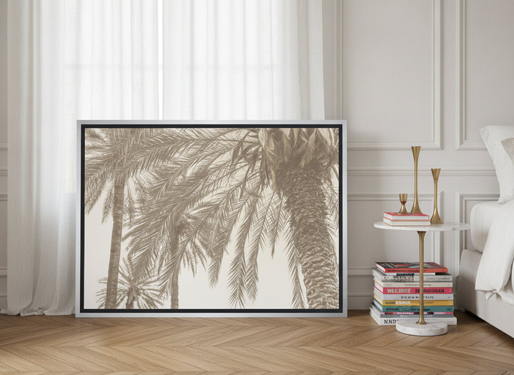 Canvas wall art with a silver leaf surround leaning against the wall in a Parisian bedroom