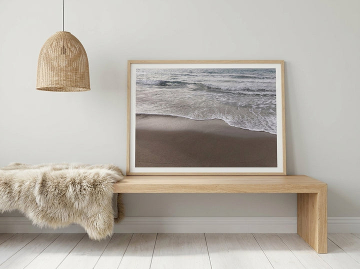 Modern wall art print standing on a bench in a bright Scandinavian bathroom