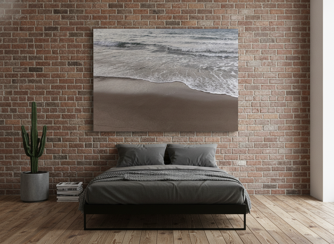 Stretched canvas wall art styled on the wall in an industrial loft bedroom
