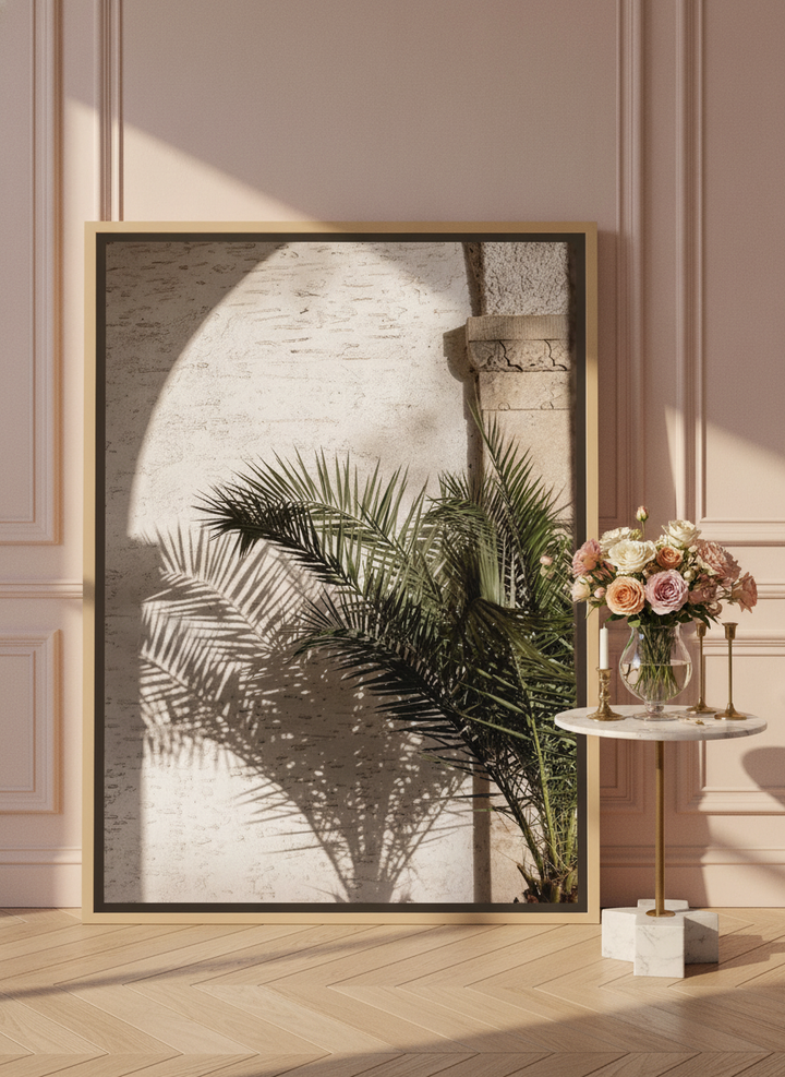 Oversized statement canvas wall art with a natural timber surround leaning against the wall in a Parisian bathroom