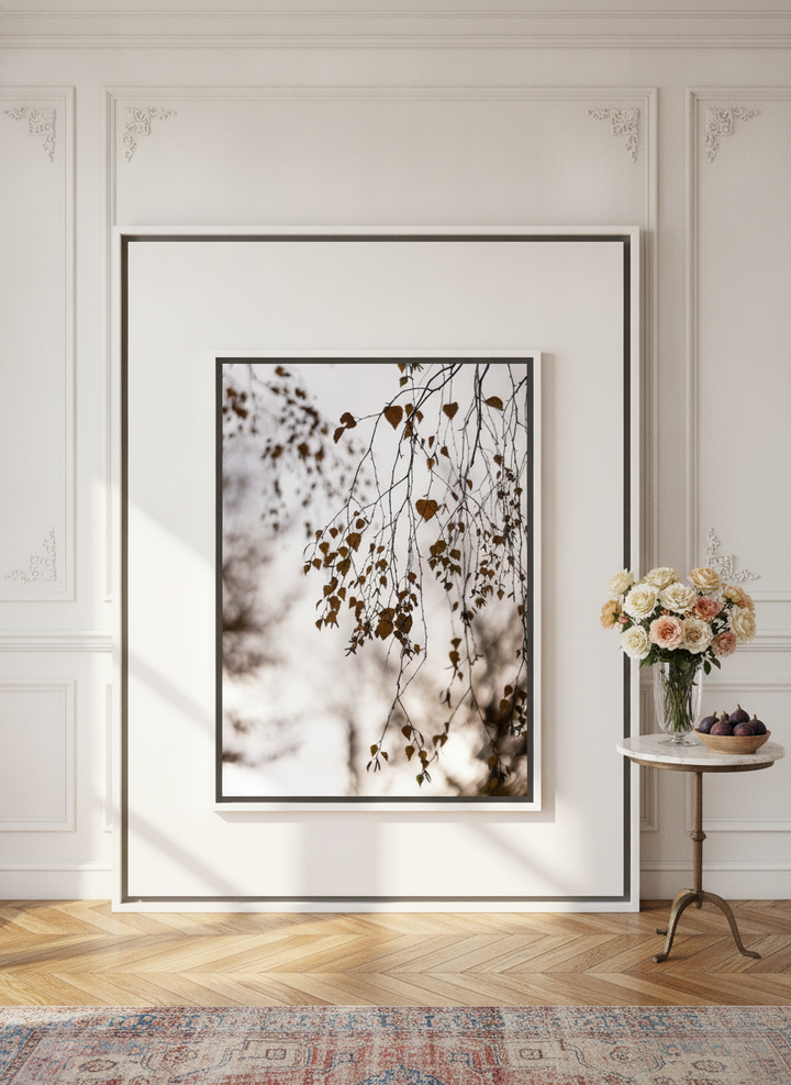 Oversized statement canvas wall art with a white surround leaning against the wall in a Parisian dining room