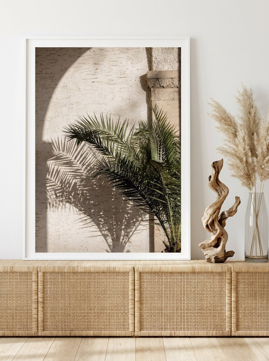 Modern wall art print standing on a sideboard in a coastal bathroom