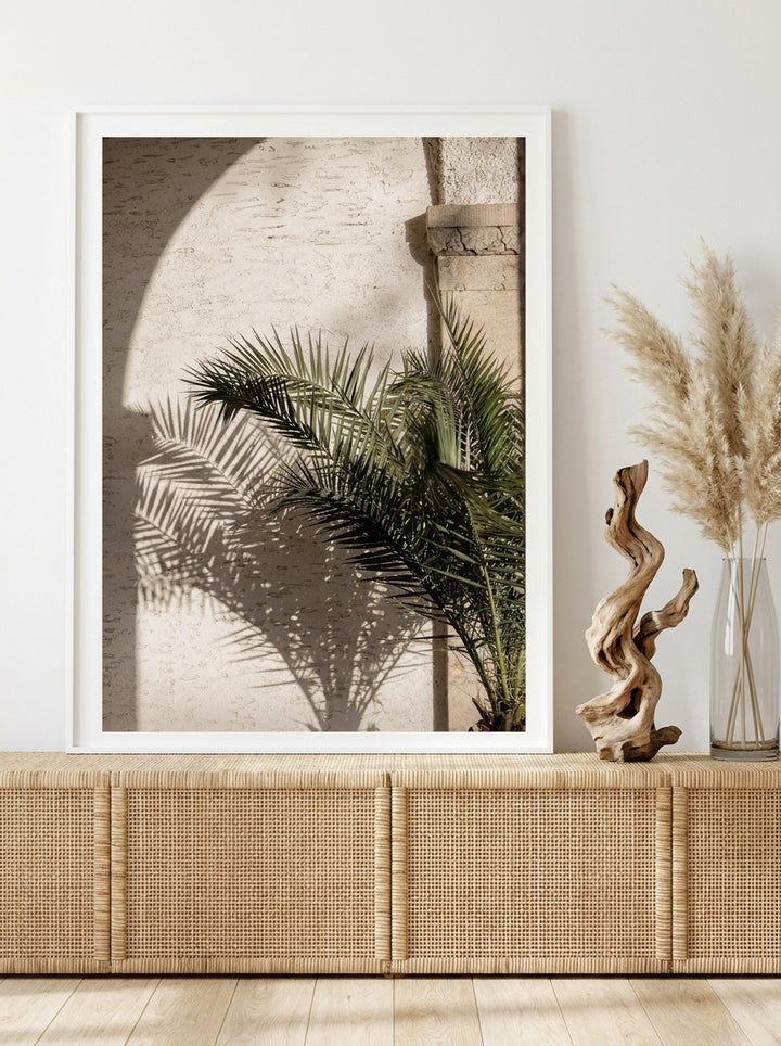 Modern wall art print standing on a sideboard in a coastal bathroom