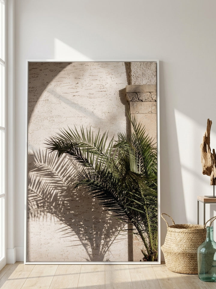 Oversized statement canvas wall art with a white surround leaning against the wall in a coastal bedroom