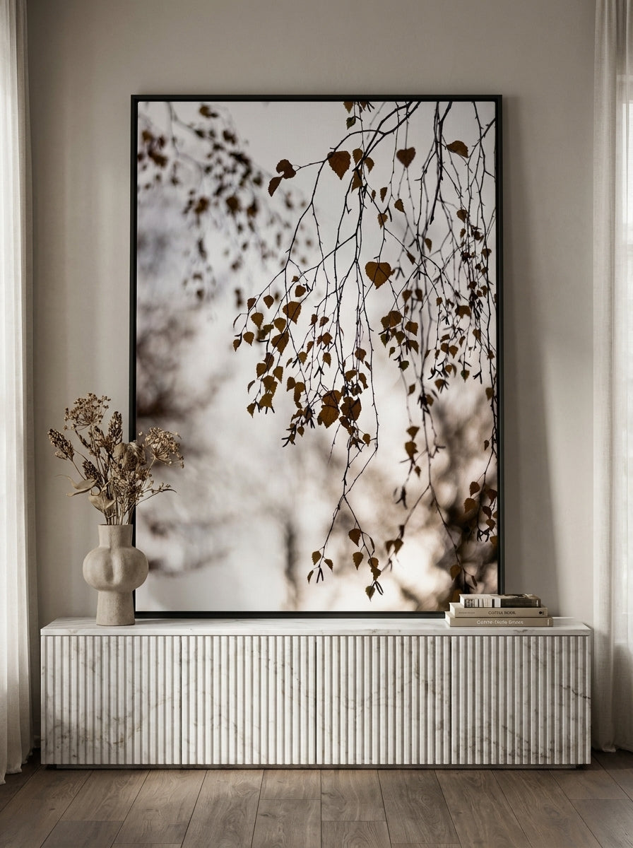 Canvas wall art with a black surround standing on a sideboard in a luxe bathroom