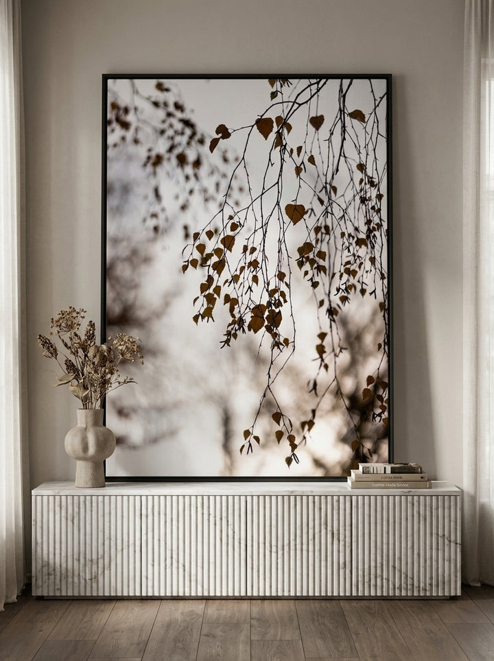 Canvas wall art with a black surround standing on a sideboard in a luxe bathroom