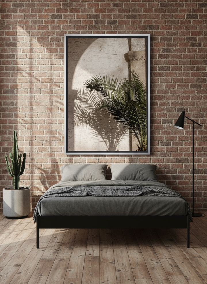 Canvas wall art with a silver leaf surround styled on the wall in an industrial loft bedroom