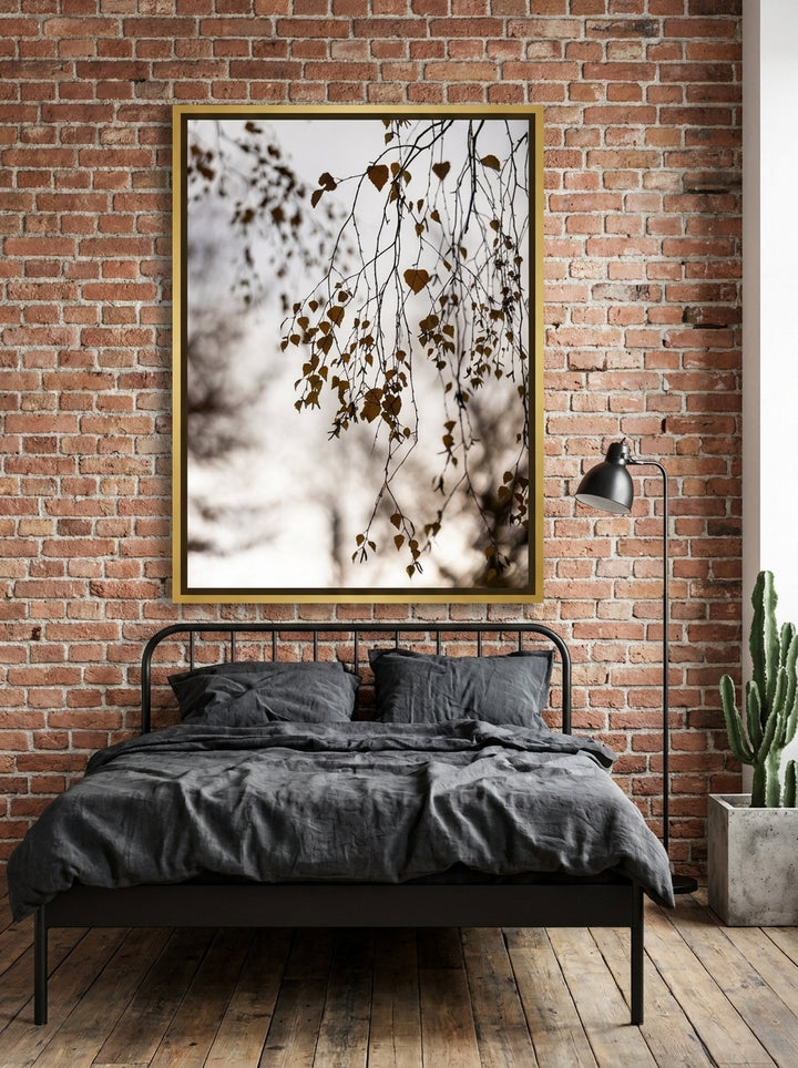 Canvas wall art with a gold leaf surround styled on the wall in an industrial loft bedroom