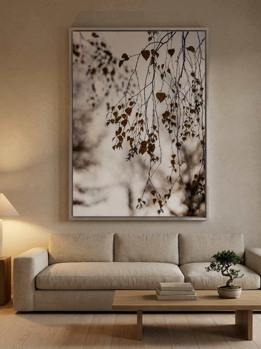 Oversized statement canvas wall art with a silver leaf surround styled on the wall in a warm Japandi living room