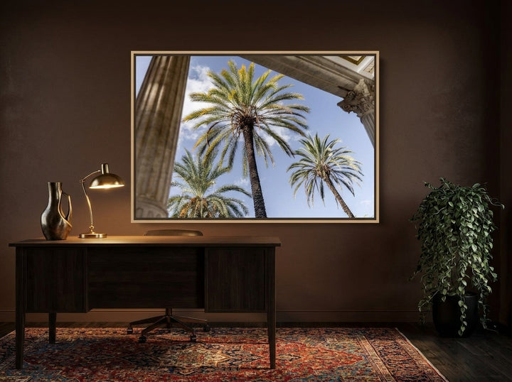 Canvas wall art with a natural timber surround styled on the wall in a moody home office