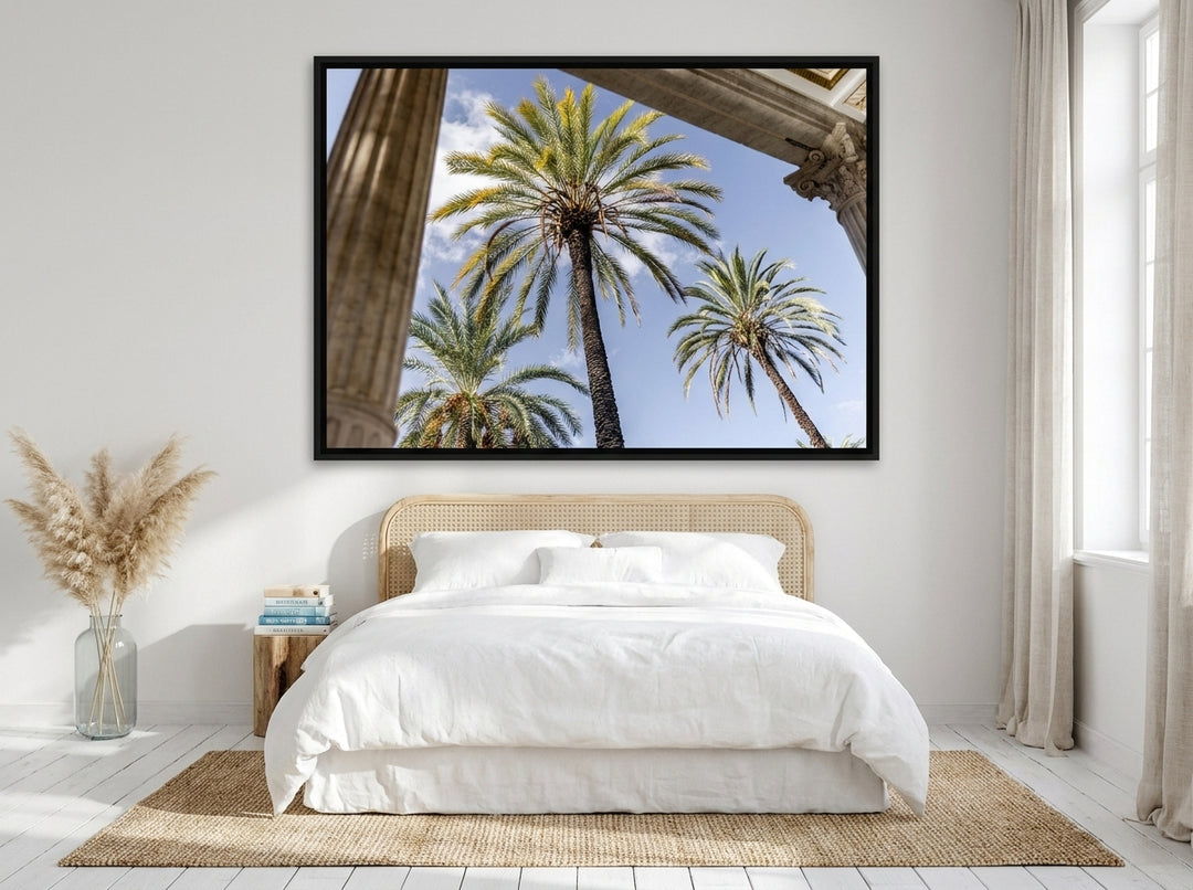 Oversized statement canvas wall art with a black surround styled on the wall in a coastal bedroom