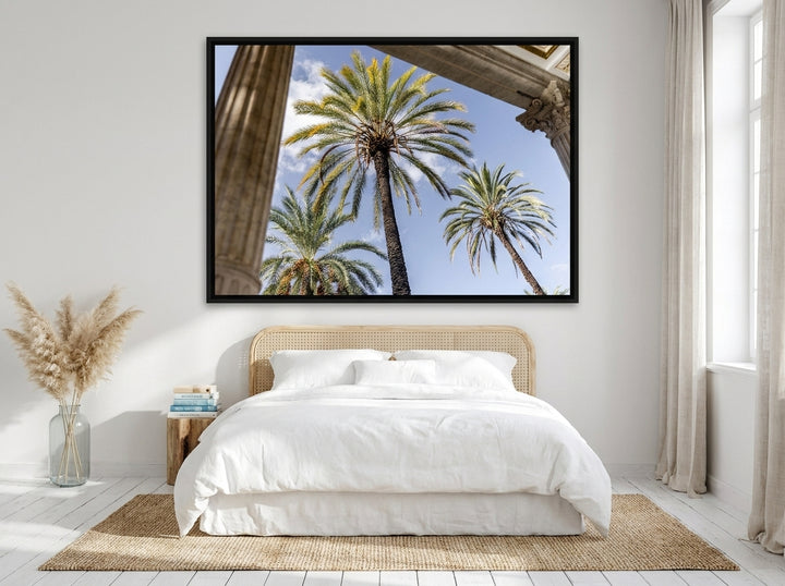Oversized statement canvas wall art with a black surround styled on the wall in a coastal bedroom
