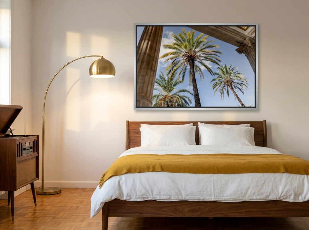 Canvas wall art with a silver leaf surround styled on the wall in a mid-century bedroom