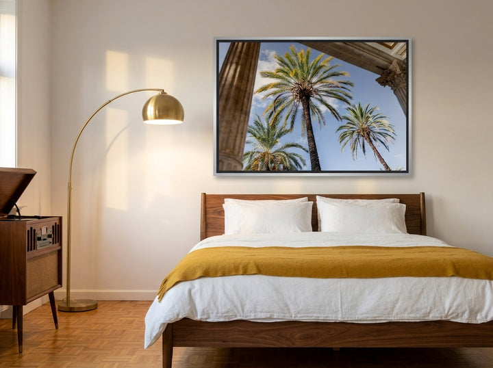 Canvas wall art with a silver leaf surround styled on the wall in a mid-century bedroom