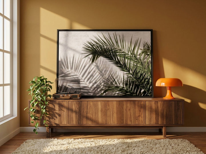 Canvas wall art with a black surround standing on a sideboard in a retro 70s home office