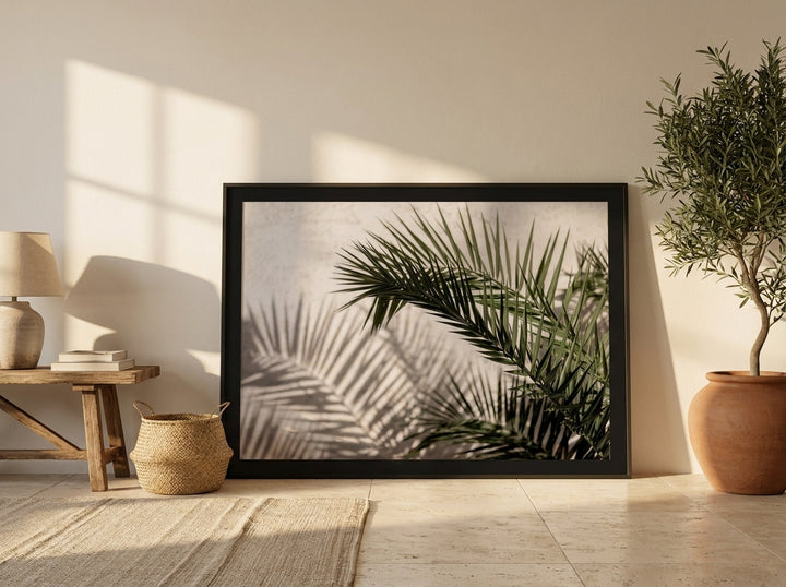 Oversized statement modern wall art print leaning against the wall in a Mediterranean bedroom