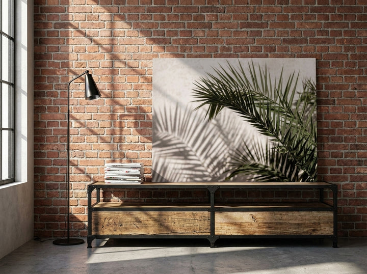 Stretched canvas wall art standing on a console in an industrial loft bedroom