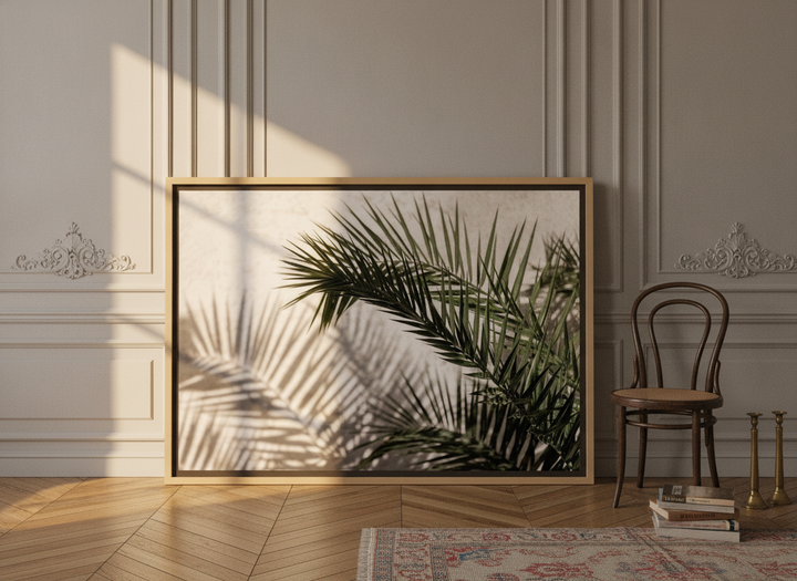 Oversized statement canvas wall art with a natural timber surround leaning against the wall in a Parisian bathroom