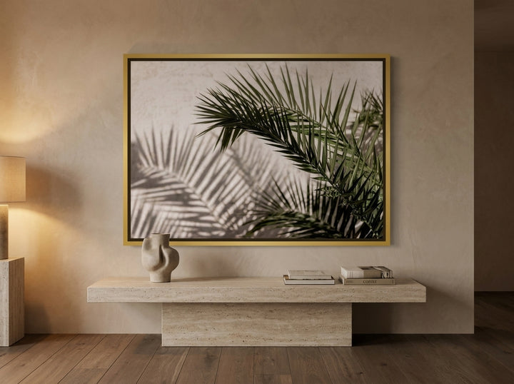 Canvas wall art with a gold leaf surround styled on the wall in a luxe living room