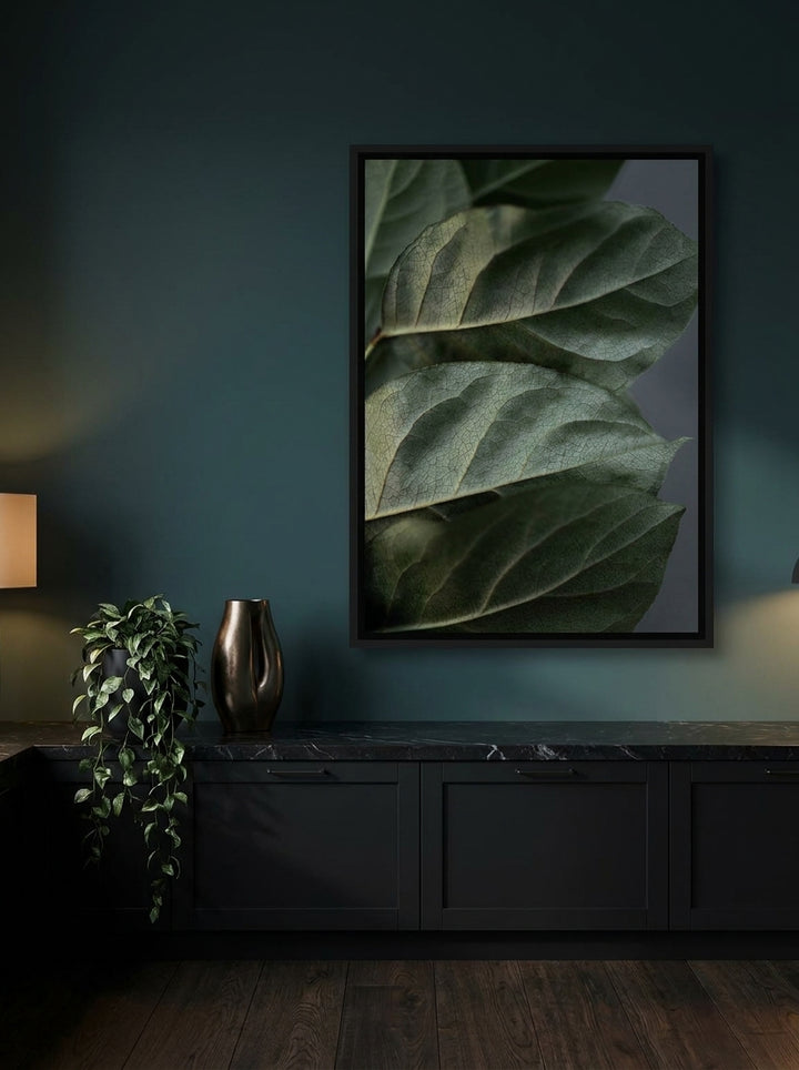 Canvas wall art with a black surround styled on the wall in a moody kitchen