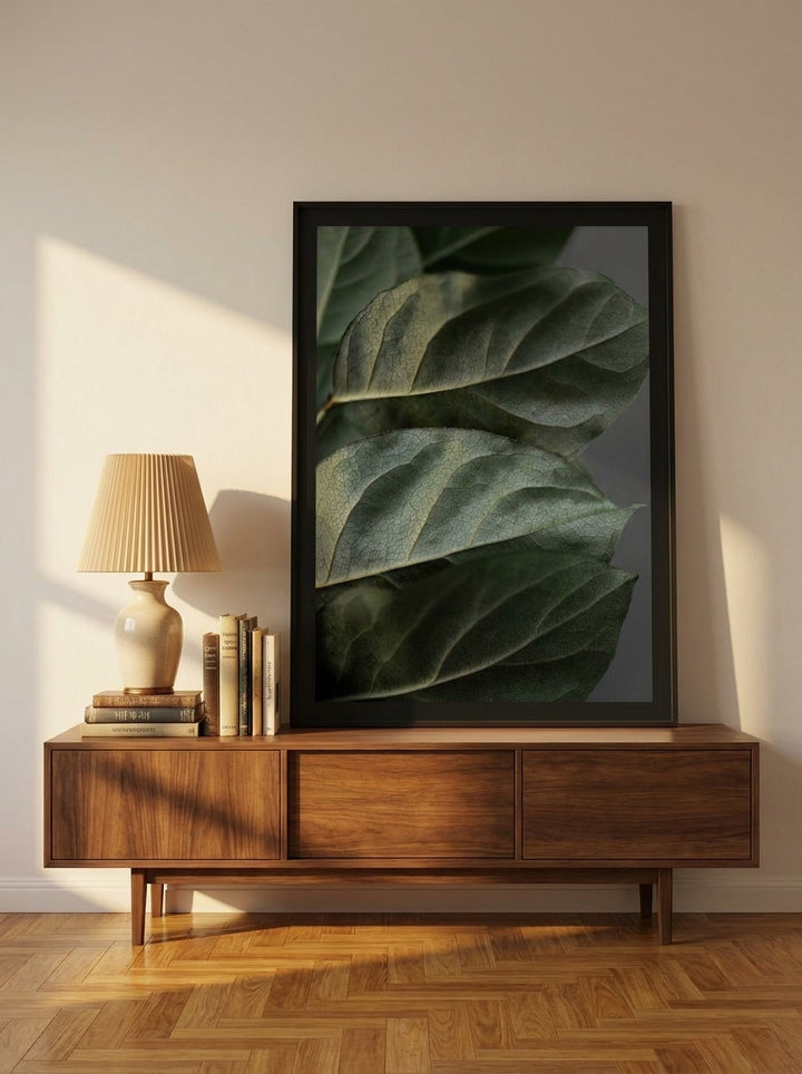 Modern wall art print standing on a sideboard in a mid-century home office