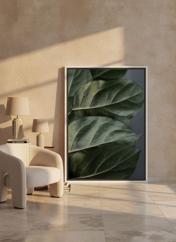 Canvas wall art with a white surround leaning against the wall in a luxe bathroom